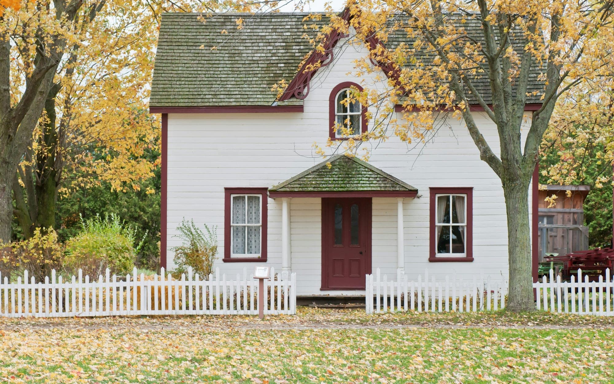 A house with a garden and a white fence