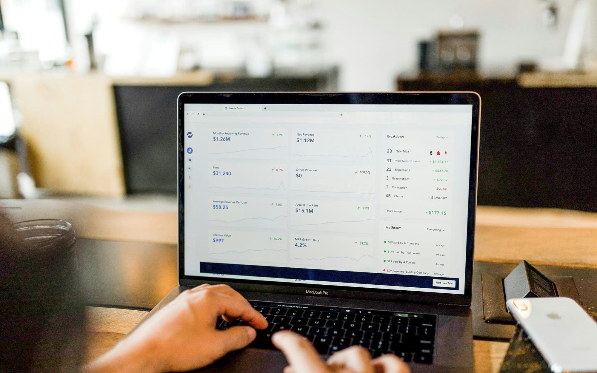 A person working at a laptop showing a list of records